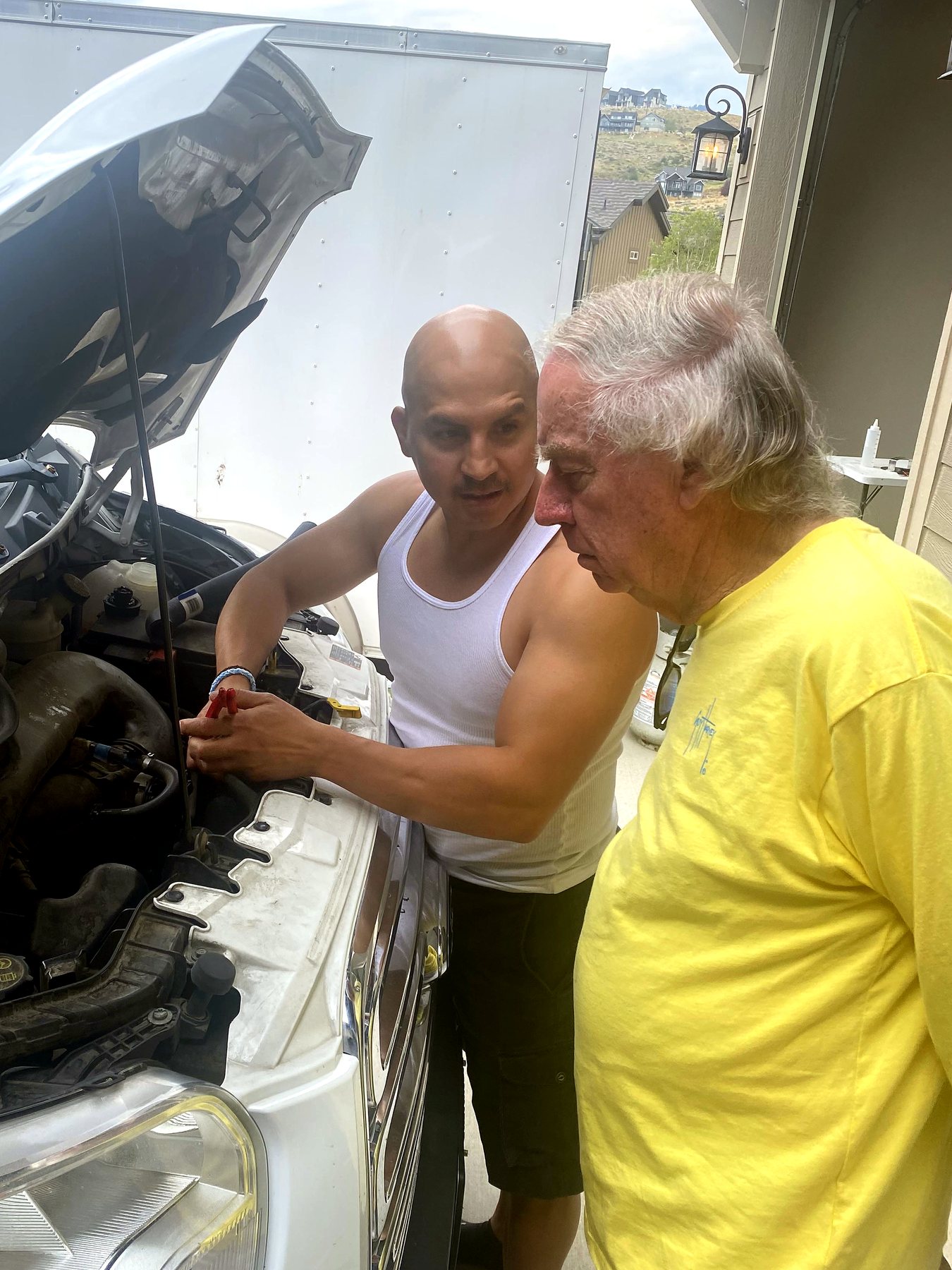 Pastor Mike Kestler with a friend at an open truck hood